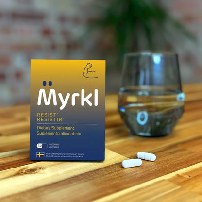 myrkl alcohol suplement next to water on table